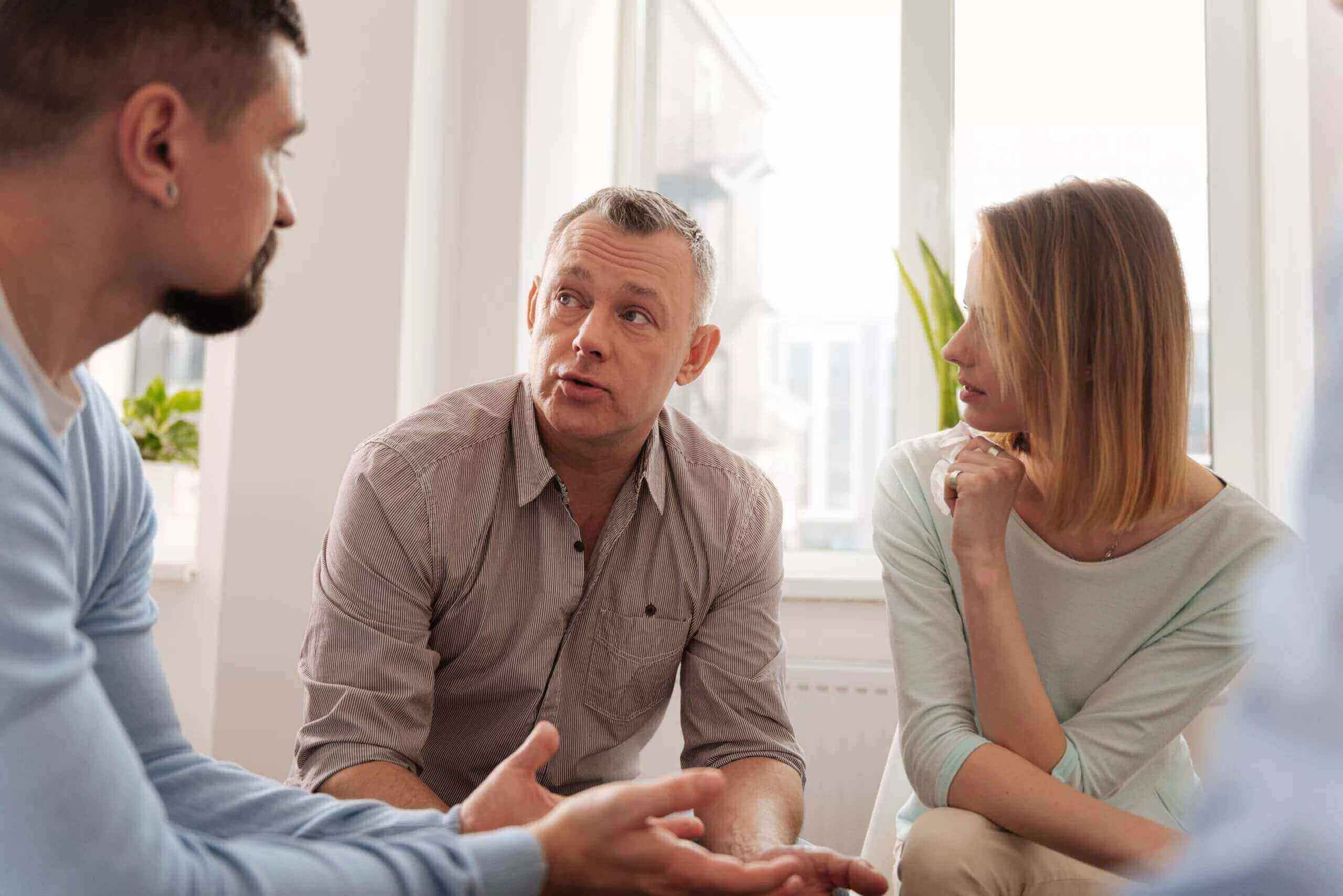 Three people engaging in a discussion